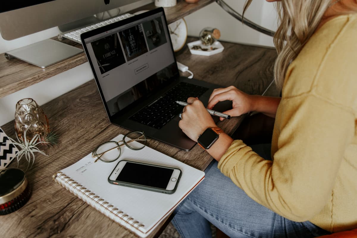 Female entrepreneur working on laptop in warm, cozy workspace